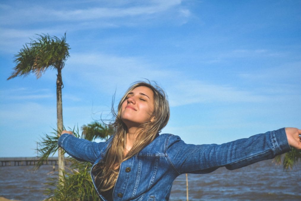 Happy young woman with arms spread wide