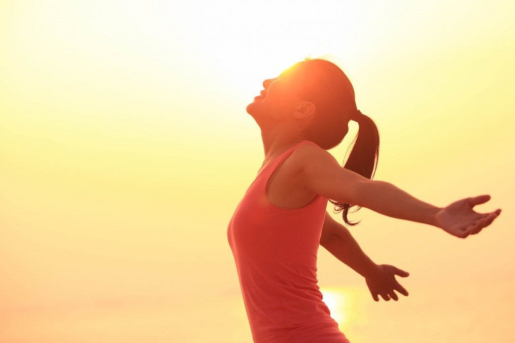 Confident woman in sunlight