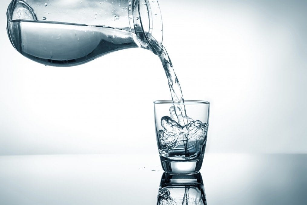 Pouring water from pitcher into a glass