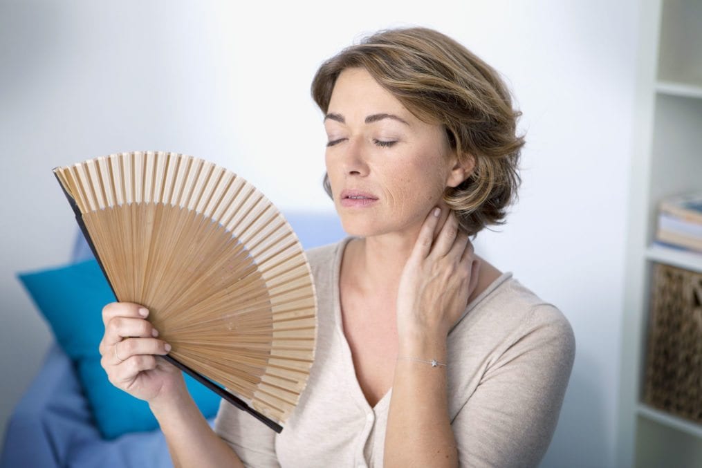 mature woman fanning herself