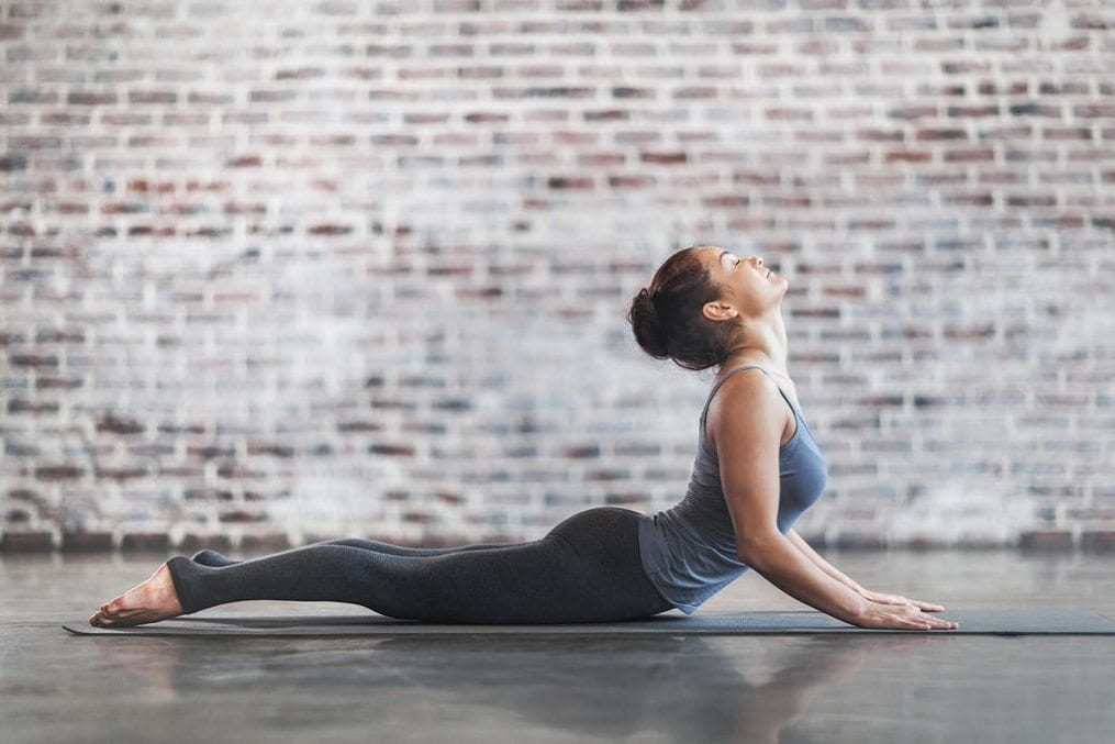 Young Woman Doing Yoga Meditation and Stretching Exercises. Stock photo.