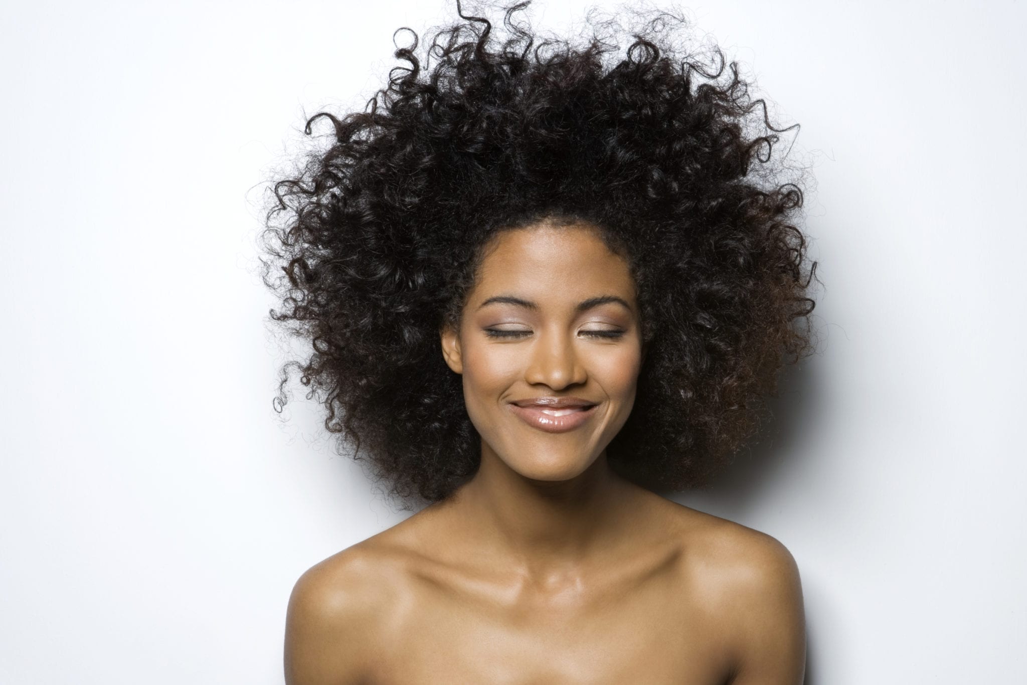 Young woman with eyes closed, smiling, close-up